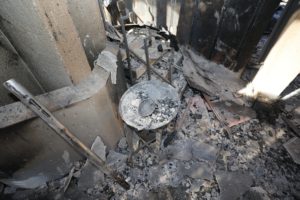 The holy water font is covered in ashes inside the destroyed Corpus Christi Church in Pacific Palisades on the west side of Los Angeles Jan. 15, 2025, in the aftermath of the wildfires. (OSV News photo/Bob Roller)