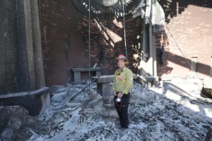 Capt. Bryan Nassour of the Los Angeles Fire Department poses inside the destroyed Corpus Christi Church in Pacific Palisades on the west side of Los Angeles Jan. 15, 2025. (OSV News photo/Bob Roller)