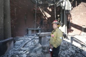 Capt. Bryan Nassour of the Los Angeles Fire Department poses inside the destroyed Corpus Christi Church in Pacific Palisades on the west side of Los Angeles Jan. 15, 2025, in the aftermath of the wildfires. Nassour and other first responders help to recover items out of the church during the fire. (OSV News photo/Bob Roller)