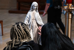 Attendees venerated the Virgin Mary statue that survived  the Eaton Fire during the OneLife LA celebration at the Cathedral of Our Lady of the Angels on Jan. 18. (Victor Alemán)