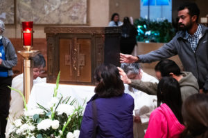 Attendees venerate the tabernacle saved from the rubble of Corpus Christi Church in the Palisades Fire during the OneLife LA celebration at the Cathedral of Our Lady of the Angels on Jan. 18. (Victor Alemán)