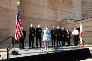 Jacky Ibarra performs the national anthem outside of the Cathedral of Our Lady of the Angels to begin the OneLife LA event on Jan. 18. (Victor Alemán)