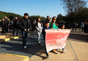 The Magallon and Gonzalez families, who both lost their homes in the Eaton Fire, process into the Cathedral of Our Lady of the Angels to begin the OneLife LA event on Jan. 18. (Victor Alemán)