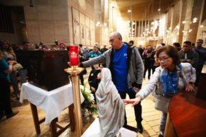 Thousands who attended the OneLife LA event on Jan. 18 venerate the Virgin Mary statue that survived  the Eaton Fire and the tabernacle saved from the rubble of Corpus Christi Church in the Palisades Fire. (Victor Alemán)