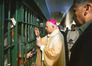 Archbishop José H. Gomez blesses inmates at LA Men's Central Jail during his annual visit and Mass on Christmas Day. (Victor Alemán)