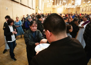 A woman receives Communion during the Ash Wednesday Mass at the Cathedral of Our Lady of the Angels on March 5, the first day of Lent. (Victor Alemán)