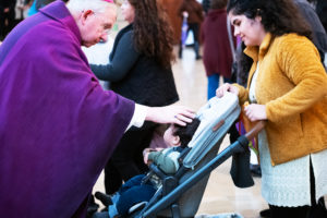 Los Angeles Archbishop José H. Gomez blesses a toddler during the Ash Wednesday Mass at the Cathedral of Our Lady of the Angels on March 5, the first day of Lent. (Victor Alemán)