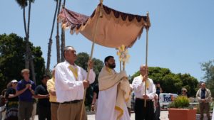 Father Eduardo Pruneda, associate pastor at Mission Basilica San Buenaventura, processes into the mission church with the Blessed Sacrament before Mass on Friday, June 20, 2025. The Mass was one of several held during the National Eucharistic Pilgrimage’s final weekend. (Katie Trejo)