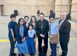 The Dyogi family from Carson stopped to take a photo with Bishop Andrew H. Cozzens of Crookston, Minn. after the June 22, 2025 Mass marking the end of the National Eucharistic Pilgrimage. (Pablo Kay)