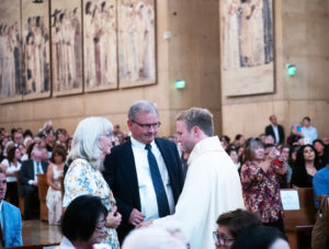 Father Paul Collins blesses his parents during the ordination Mass at the Cathedral of Our Lady of the Angels on May 31.(Victor Alemán)