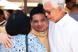 Father Johndy Gonzales gets hugs from loved ones following the new priests ordination Mass on May 31.(Victor Alemán)