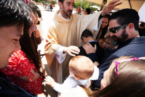 Father Michael Croghan offers a first blessing to his family following the ordination Mass at the Cathedral of Our Lady of the Angels on May 31. (Victor Alemán)