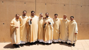 The newly ordained priests Father Allan Carodan, Father Michael Croghan, Father Jorge Moncada, Father Joseph Cruz, Father Christian Morquecho, Father Quoc Vo, Father Paul Collins, and Father Johndy Gonzales share a lighthearted moment following their ordination Mass on May 31. (Victor Alemán)