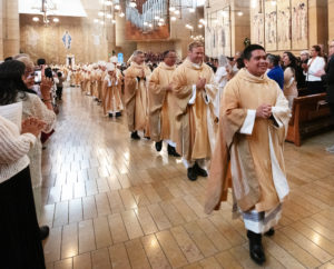 The eight newly ordained priests receive applause processing out following the ordination Mass at the Cathedral of Our Lady of the Angels on May 31. (Victor Alemán)