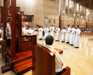 The eight men entering the priesthood stand before Archbishop José  H. Gomez during the ordination Mass at the Cathedral of Our Lady of the Angels on May 31. (Victor Alemán)