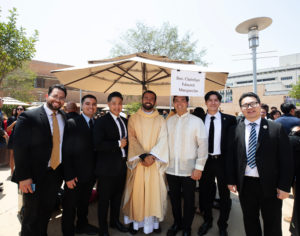 Father Christian Morquecho poses with loved ones following the new priests ordination Mass on May 31. (Victor Alemán)