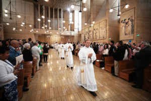 The eight men to be ordained as new priests process into the Cathedral of Our Lady of the Angels for their ordination Mass on May 31. (Victor Alemán)