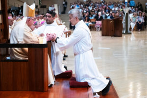 Archbishop José H. Gomez blesses newly ordained Father Joseph Cruz during the ordination Mass at the Cathedral of Our Lady of the Angels on May 31. (Victor Alemán)