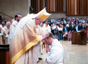 Archbishop José H. Gomez blesses newly ordained Father Paul Collins during the ordination Mass at the Cathedral of Our Lady of the Angels on May 31. (Victor Alemán)