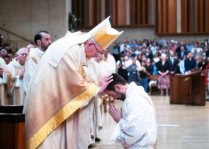 Archbishop José H. Gomez blesses newly ordained Father Michael Croghan during the ordination Mass at the Cathedral of Our Lady of the Angels on May 31. (Victor Alemán)