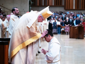 Archbishop José H. Gomez blesses newly ordained Father Johndy Gonzales during the ordination Mass at the Cathedral of Our Lady of the Angels on May 31. (Victor Alemán)