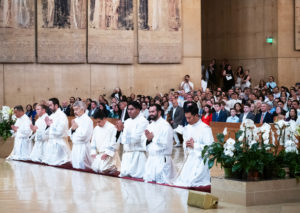 Moments before becoming priests, the eight men of the LA Archdiocese’s Class of 2025 kneel in prayer during their May 31 ordination Mass at the Cathedral of Our Lady of the Angels. (Victor Alemán)