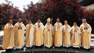The newly ordained priests pose with Archbishop José H. Gomez following their ordination Mass on May 31 (from left): Father Allan Carodan, Father Christian Morquecho, Father Quoc Vo, Father Jorge Moncada, Father Michael Croghan, Father Paul Collins, Father Johndy Gonzales, and Father Joseph Cruz. (Victor Alemán)