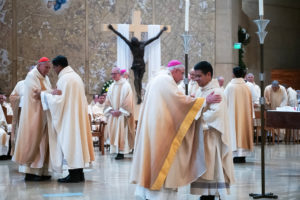 Archbishop José H. Gomez offers the kiss of peace to newly ordained Father Johndy Gonzales during the ordination Mass at the Cathedral of Our Lady of the Angels on May 31. (Victor Alemán)