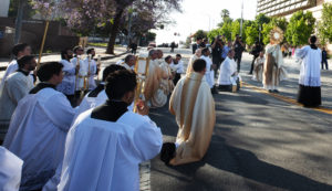 Others kneel while Archbishop José H. Gomez, blesses the city with a monstrance following a Mass for the feast of Corpus Christi at the Cathedral of Our Lady of the Angels on June 22 during the National Eucharistic Pilgrimage. (Victor Alemán)