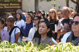 Worshippers stand outside Mission Basilica San Buenaventura during a Eucharistic procession on June 20 during the National Eucharistic Pilgrimage’s final weekend. (Katie Trejo)