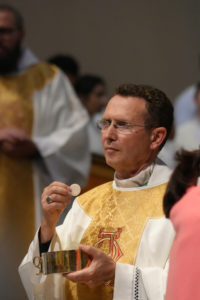 Bishop Andrew H. Cozzens of Crookston, Minn. offers holy Communion to attendees of the Mass at Sacred Heart Church in Altadena on June 20 as part of the National Eucharistic Pilgrimage. (Katie Trejo)