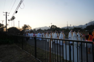 Hundreds participating in the National Eucharistic Pilgrimage procession through the streets of Altadena on June 20 passed several empty lots that once contained the homes burned down in the Eaton Fire. (Katie Trejo)