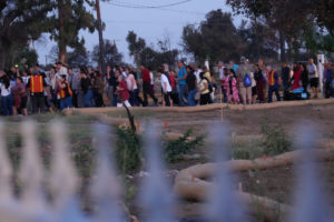 Hundreds participating in the National Eucharistic Pilgrimage procession through the streets of Altadena on June 20 passed several empty lots that once contained the homes burned down in the Eaton Fire. (Katie Trejo)