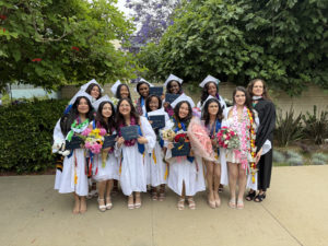 Haide Hernandez, front row left, and Jedesa Alatorre, front row fifth from left, pose with other St. Mary’s Academy graduates following their commencement ceremony on June 7. (Alatorre Family)
