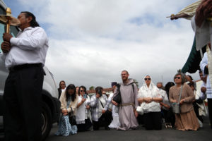 The faithful kneel in the parking lot at St. Vincent DePaul Church in Los Angeles, where the National Eucharistic Pilgrimage offered Eucharistic adoration at the parish on June 21. (Katie Trejo)