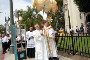 Father Gary Mueller, CM, pastor at St. Vincent DePaul Church in Los Angeles, carries the monstrance holding the Blessed Sacrament down Figueroa Street during Day 2 of the National Eucharistic Pilgrimage’s appearance in LA on June 21. (Katie Trejo)