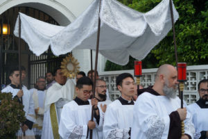 Father Louie Reyes carries the Blessed Sacrament out of St. Frances Xavier Chapel to begin a Eucharistic procession through Skid Row in downtown Los Angeles on July 19. (Alex Salcedo)