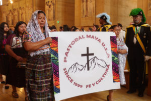 Attendees carry a banner during the procession to kick off the “One Mother, Many Peoples” Mass at the Cathedral of Our Lady of the Angels on Sept. 6, which celebrated the diverse cultures, organizations, and ethnic ministries in the Archdiocese of Los Angeles. (Reese Cuevas/Archdiocese of Los Angeles)