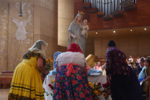 Attendees lay flowers in front of the Virgin Mary statue during the “One Mother, Many Peoples” Mass at the Cathedral of Our Lady of the Angels on Sept. 6, which celebrated the diverse cultures, organizations, and ethnic ministries in the Archdiocese of Los Angeles. (Reese Cuevas/Archdiocese of Los Angeles)