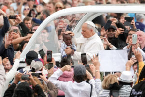 Pope Leo XIV greets a child from the popemobile as he rides around St. Peter’s Square following Mass for the Jubilee of Migrants and the Jubilee of the Missions in St. Peter’s Square at the Vatican Oct. 5, 2025. (CNS photo/Lola Gomez)