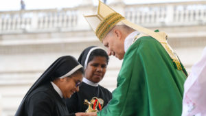 Pope Leo XIV accepts the offertory gifts from two religious sisters during Mass for the Jubilee of Migrants and the Jubilee of the Missions in St. Peter’s Square at the Vatican Oct. 5, 2025. (CNS photo/Vatican Media)