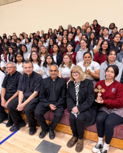 Msgr. Anthony Figueiredo, front center, Father Mario Torres, center left, and Father Michael Semana, far left, pose with Principal 
Robyn Carroll and students with the relics of St. Carlo Acutis at Bishop Conaty - Our Lady of Loretto High School on Oct. 21 during a tour of the saint's relics. (Bishop Conaty - Our Lady of Loretto High School)