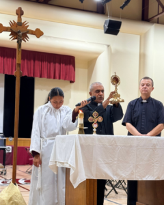 Msgr. Anthony Figueiredo, a priest in Assisi, Italy, displays the relics of St. Carlo Acutis at Bishop Conaty - Our Lady of Loretto High School on Oct. 21 during a tour of the saint's relics. (Bishop Conaty - Our Lady of Loretto High School)