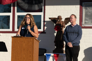 Holy Angels Principal Aimee Dyrek, left, and Father Kevin Rettig, right, the pastor at Holy Angels Church, speak during a Veterans Day event at Holy Angels School in Arcadia on Nov. 10. (Lawrence Lane)