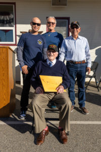 Joe “Peppy” Sciarra, a 100-year-old World War II veteran, poses with Mervin Vergara, top left, a school parent who is currently serving in the U.S. Navy, Sciarra’s son, Joe, top center, and Aurelio Anaya, a Vietnam War veteran, top right, during a Veterans Day event at Holy Angels School in Arcadia on Nov. 10. (Lawrence Lane)
