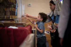 A young boy looks in front of the St. Thérèse reliquary at the Sacred Heart Retreat House in Alhambra on Oct. 13 during a U.S. tour of the saint's relics. (Jeffrey Bruno)