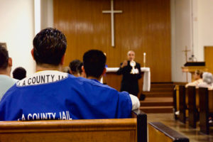Msgr. Anthony Figueiredo, a priest in Assisi, Italy, speaks to inmates at LA Men’s Central Jail about the life of St. Carlo Acutis before Mass Oct. 20.   (Reese Cuevas)