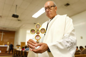 Deacon Fermin Lopez holds the relic of St. Carlo Acutis during a tour of the saint's relics to LA Men’s Central Jail on Oct. 20. (Reese Cuevas)