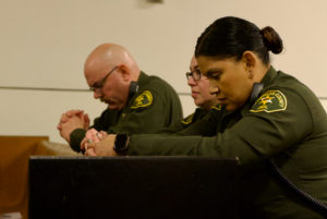 Sheriff’s deputies working at the jail pray during Mass in honor of St. Carlo Acutis' relic visit to LA Men’s Central Jail on Oct. 20. (Reese Cuevas)