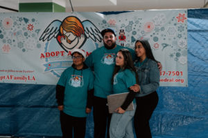 Volunteers pose for photos during the annual Adopt-a-Family LA  gift distribution event on Dec. 13 at the Cathedral of Our Lady of the Angels. (Peter Lobato)